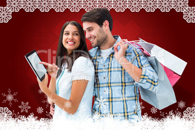 Composite image of happy couple with shopping bags