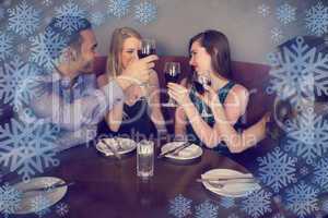 Composite image of smiling friends clinking wine glasses