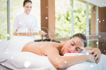 Beautiful woman receiving stone massage at health farm