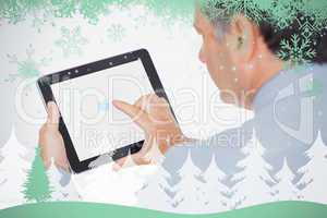 Mature businessman using digital tablet