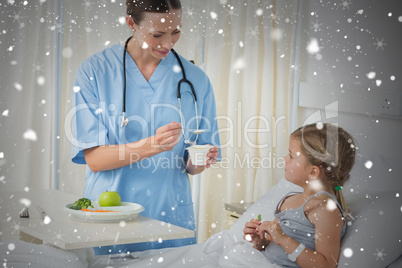 Composite image of doctor feeding meal to sick girl