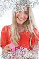 Composite image of smiling woman with gift box