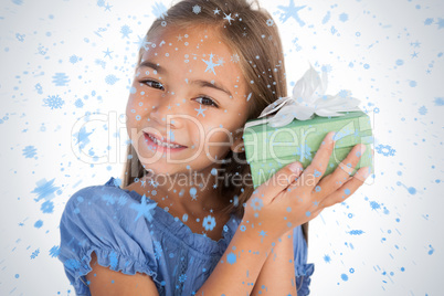 Smiling girl excited while holding a present