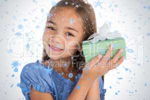 Smiling girl excited while holding a present