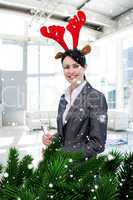 Composite image of smiling businesswoman with a novelty christma