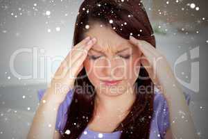 Composite image of young woman with headache at home