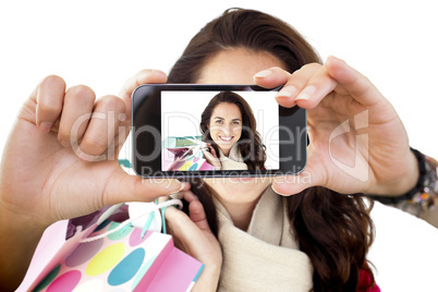 Composite image of hand holding smartphone showing