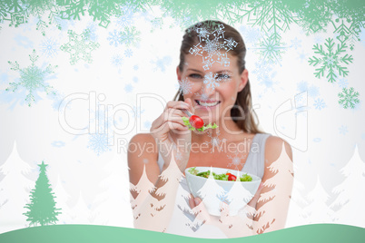 Smiling woman eating a salad