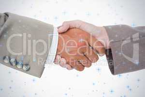 Side view of business peoples hands shaking