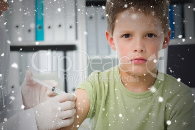 Boy receiving an injection by pediatrician