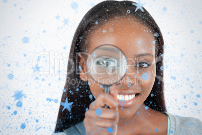 Composite image of young woman with magnifier