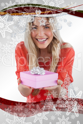 Composite image of young woman offering gift