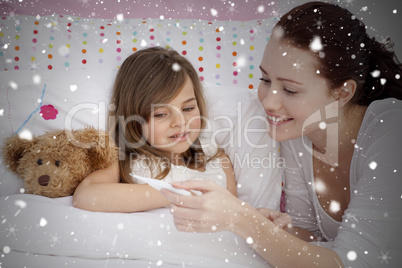 Composite image of mother taking her daughters temperature