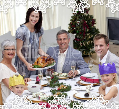 Family celebrating christmas dinner with turkey