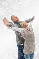 Composite image of happy mature couple in winter clothes