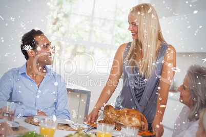 Composite image of happy wife bringing turkey to the table