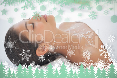 Beautiful brunette lying on massage table with salt scrub on che