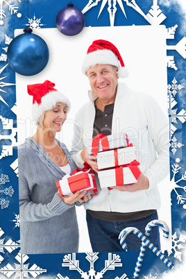 Composite image of festive mature couple in winter clothes holding gifts