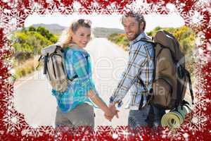 Attractive couple standing on the road holding hands smiling at