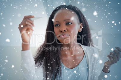 Composite image of close up of woman measuring her temperature