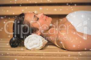 Peaceful brunette relaxing in a sauna