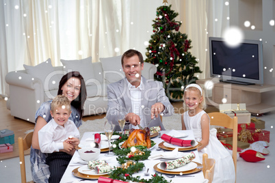 Family celebrating christmas dinner with turkey