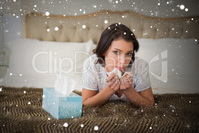 Composite image of calm pretty brown haired woman sneezing in a