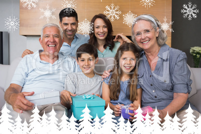 Composite image of extended family on sofa with gift boxes in li
