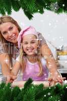 Composite image of mother and daughter baking christmas cookies