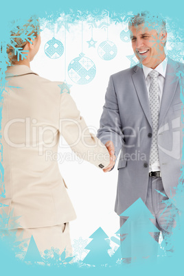 Composite image of happy business people shaking hands