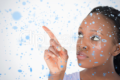 Close up of woman pointing at something next to her on a white b
