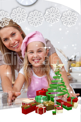 Mother and daughter baking christmas cookies in the kitchen