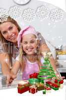Mother and daughter baking christmas cookies in the kitchen