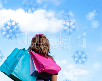 Composite image of woman holding shopping bags outdoor