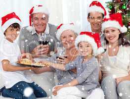 Composite image of family drinking wine and eating sweets in chr