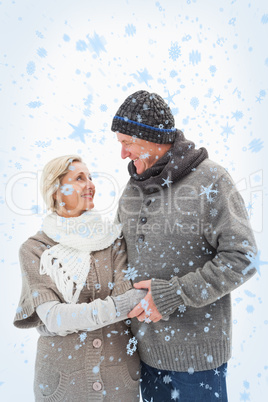 Composite image of happy mature couple in winter clothes