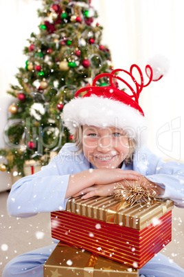 Composite image of portrait of a smiling boy wearing a christmas