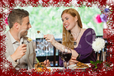 Composite image of happy couple eating together