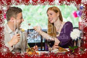 Composite image of happy couple eating together