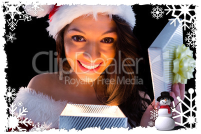 Pretty brunette in santa outfit opening gift