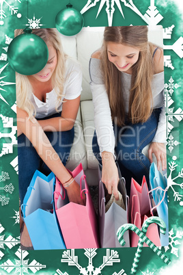 Composite image of a smiling pair of girls looking at the shopping