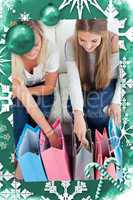 Composite image of a smiling pair of girls looking at the shopping