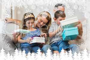 Composite image of family opening gifts on sofa