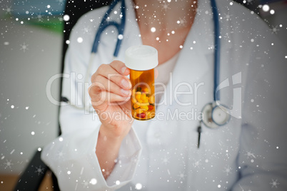 Close up of a female doctor holding pills into the camera