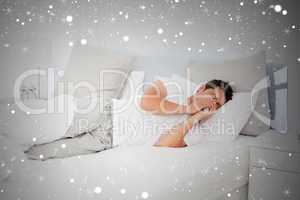 Composite image of sick man blowing his nose lying on his bed