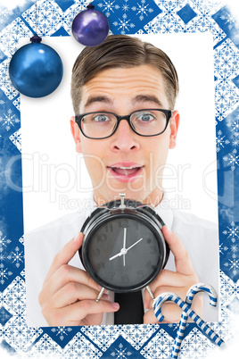 Geeky businessman holding alarm clock