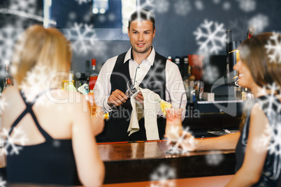 Handsome bartender working while gorgeous friends speaking