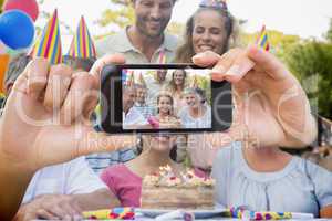 Composite image of hand holding smartphone showing