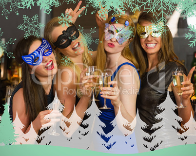 Attractive women wearing masks holding champagne