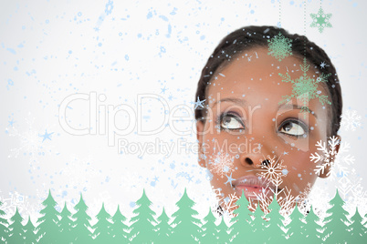 Close up of womans face looking upwards diagonally on white background